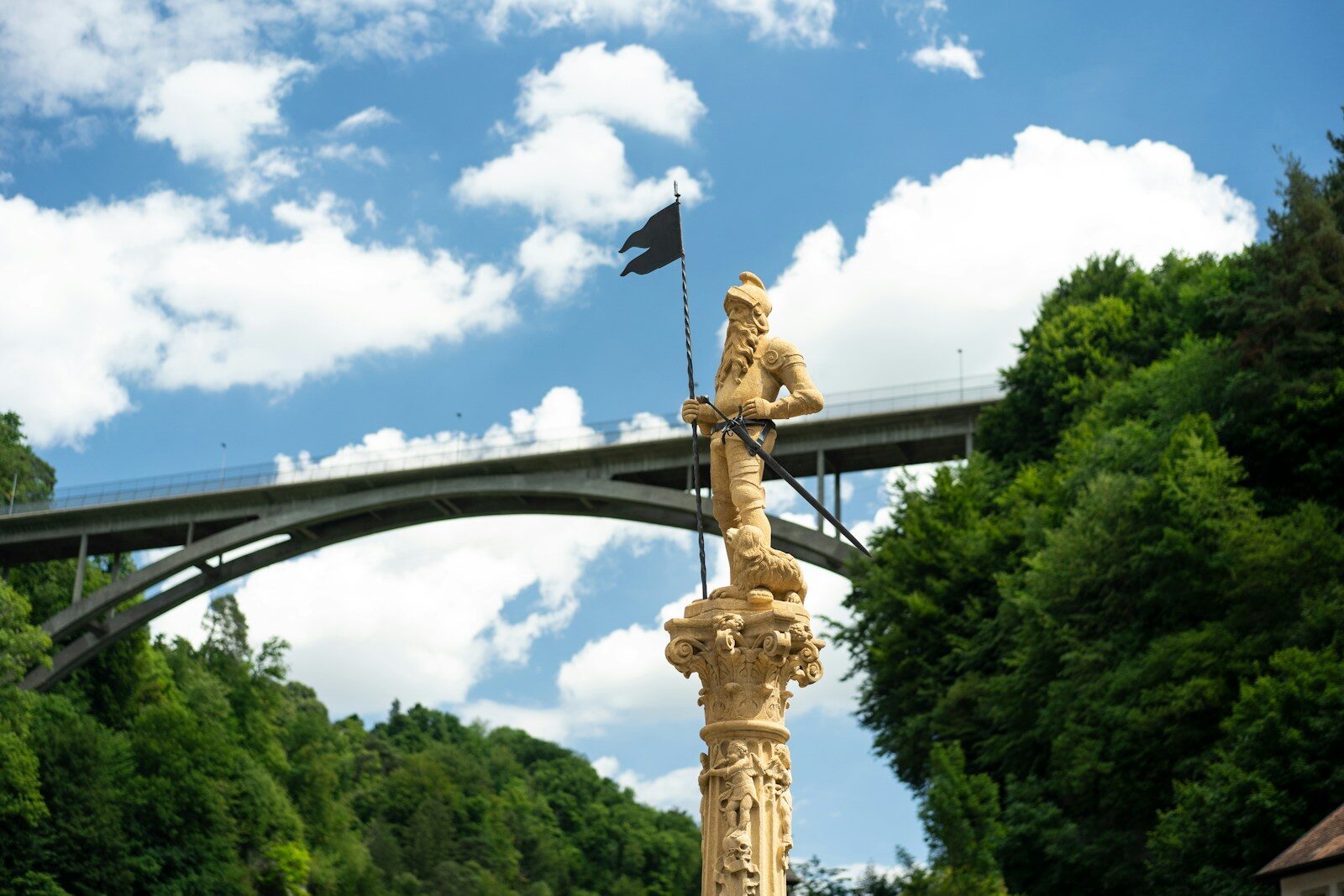 a statue of a person holding a flag and a flag